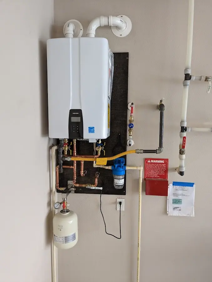 Professional plumber installing copper piping in a East Lampeter home